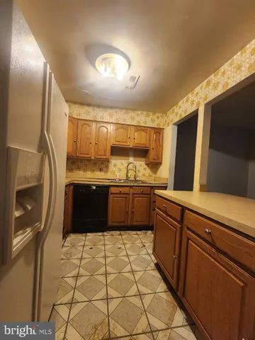 a kitchen with stainless steel appliances a sink and a stove