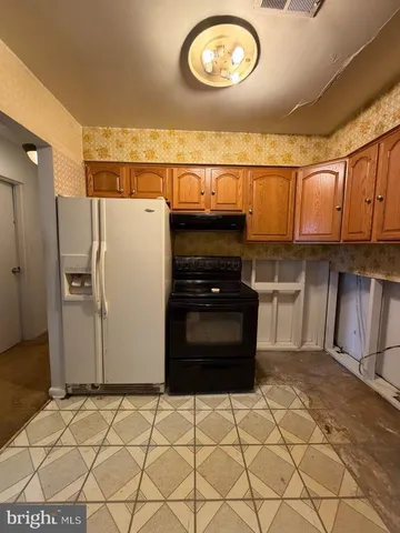 a kitchen with a refrigerator and a stove