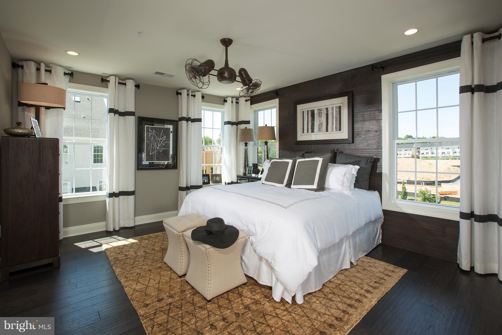 2603 Maple Rock Road Hanover, MD 21076 - Photo 12 of 22 a spacious bedroom with a bed a window and a chandelier