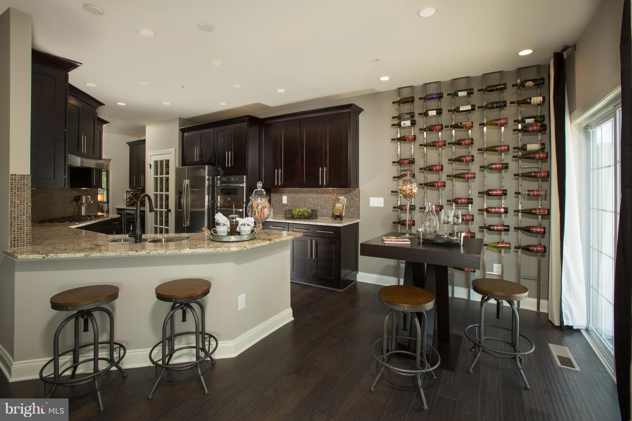 2603 Maple Rock Road Hanover, MD 21076 - Photo 5 of 22 a kitchen with a sink and chairs
