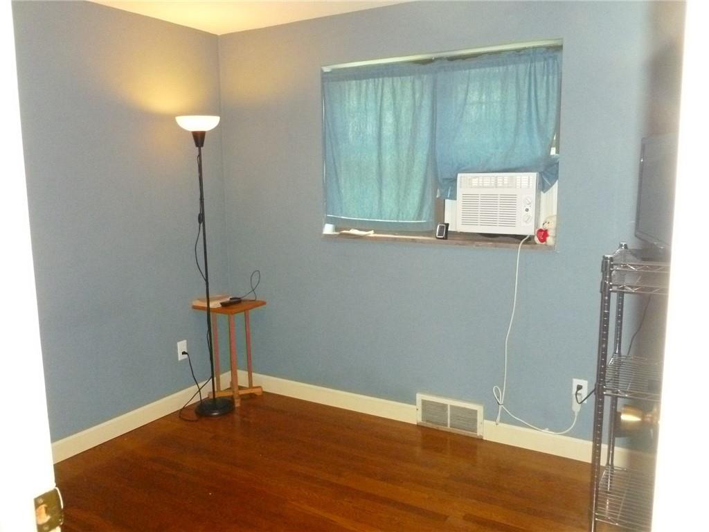 28 Kenridge Drive McKees Rocks, PA 15136 - Photo 14 of 26 a view of an empty room with wooden floor and a window