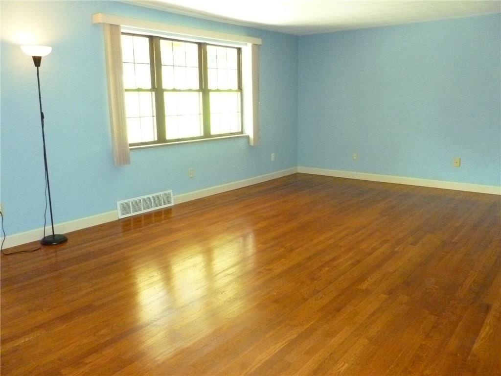 28 Kenridge Drive McKees Rocks, PA 15136 - Photo 6 of 26 an empty room with wooden floor and windows