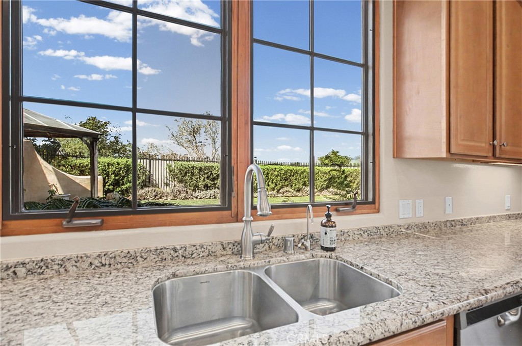 860 Vista Del Rio Nipomo, CA 93444 - Photo 15 of 45 a kitchen with a sink a counter top space and cabinets