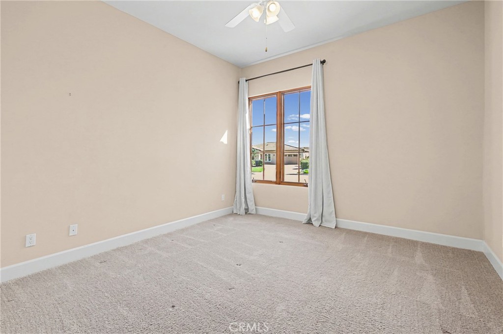 860 Vista Del Rio Nipomo, CA 93444 - Photo 20 of 45 an empty room with windows and chandelier fan