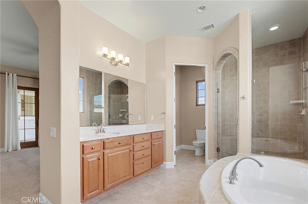 860 Vista Del Rio Nipomo, CA 93444 - Photo 25 of 45 a spacious bathroom with a bathtub shower sink mirror and toilet