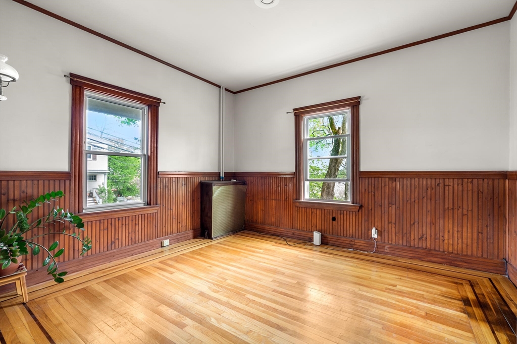 511 Beech Street Boston, MA 02131 - Photo 11 of 14 a bedroom with a bed and a window