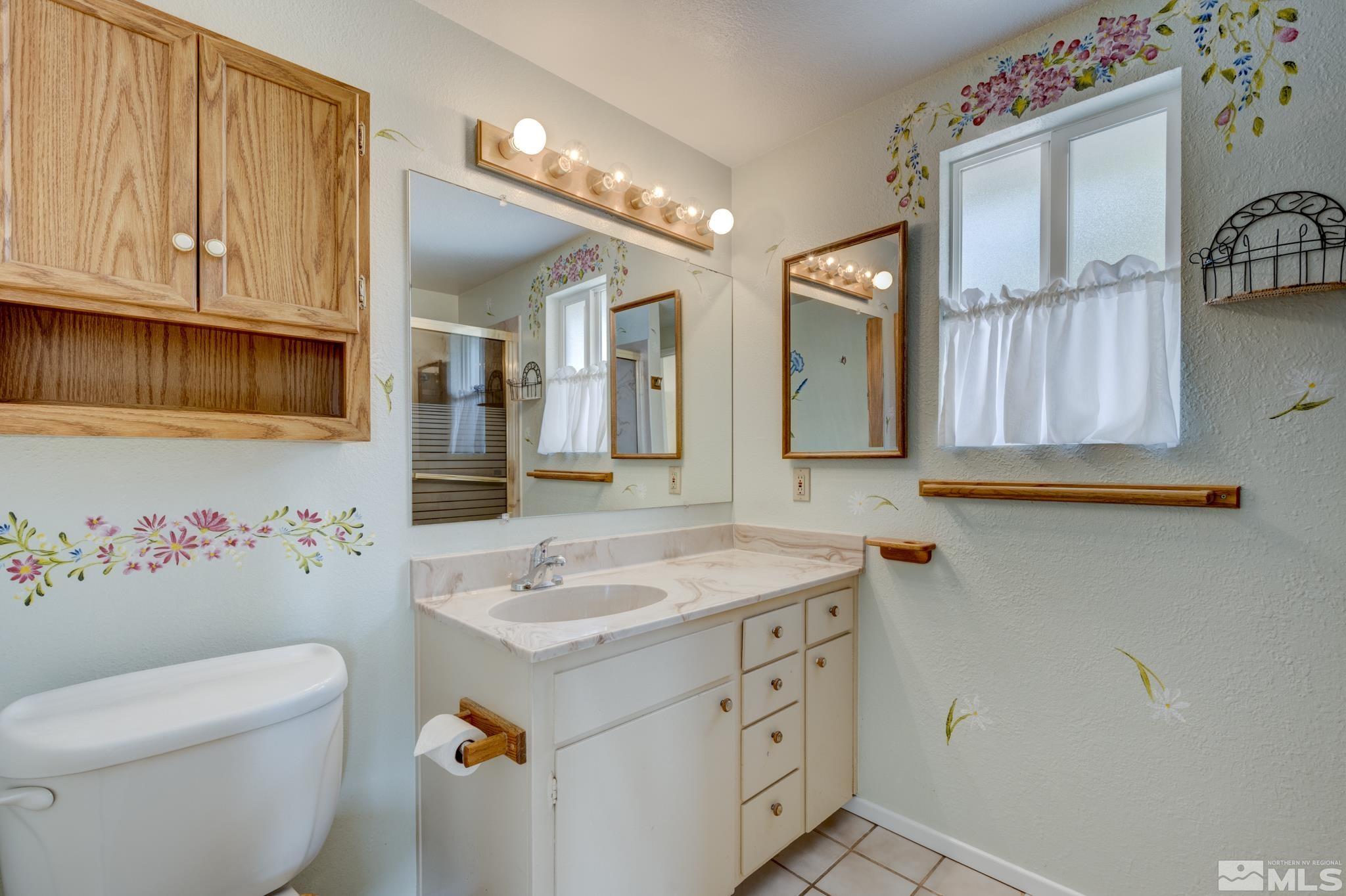 1700 O Farrell Street Reno, NV 89503 - Photo 13 of 22 a bathroom with a sink vanity mirror and toilet