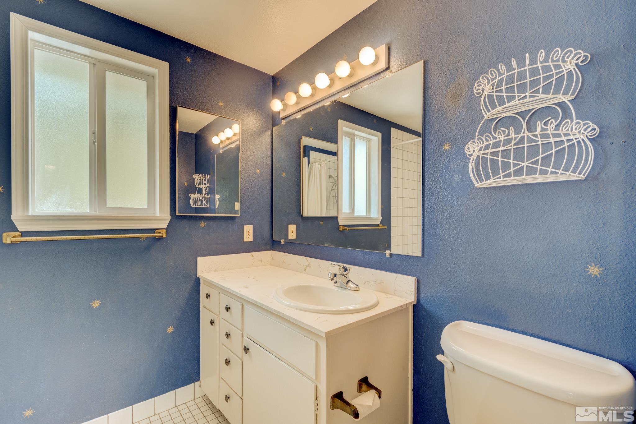 1700 O Farrell Street Reno, NV 89503 - Photo 16 of 22 a bathroom with a sink a toilet and mirror