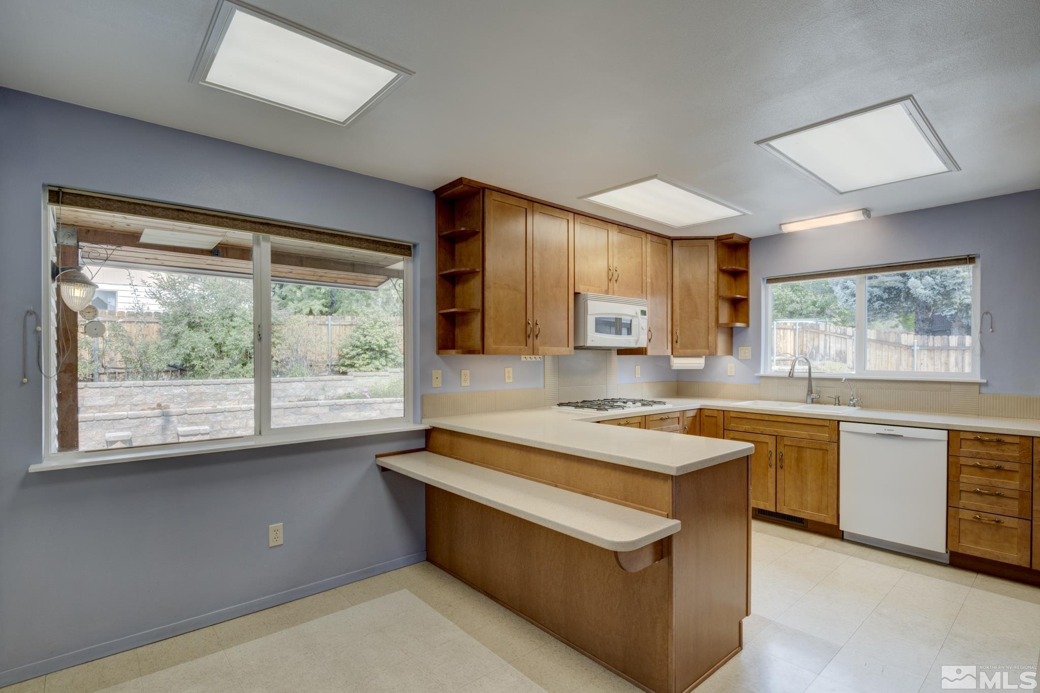 1700 O Farrell Street Reno, NV 89503 - Photo 2 of 22 a kitchen with a stove a sink and a refrigerator