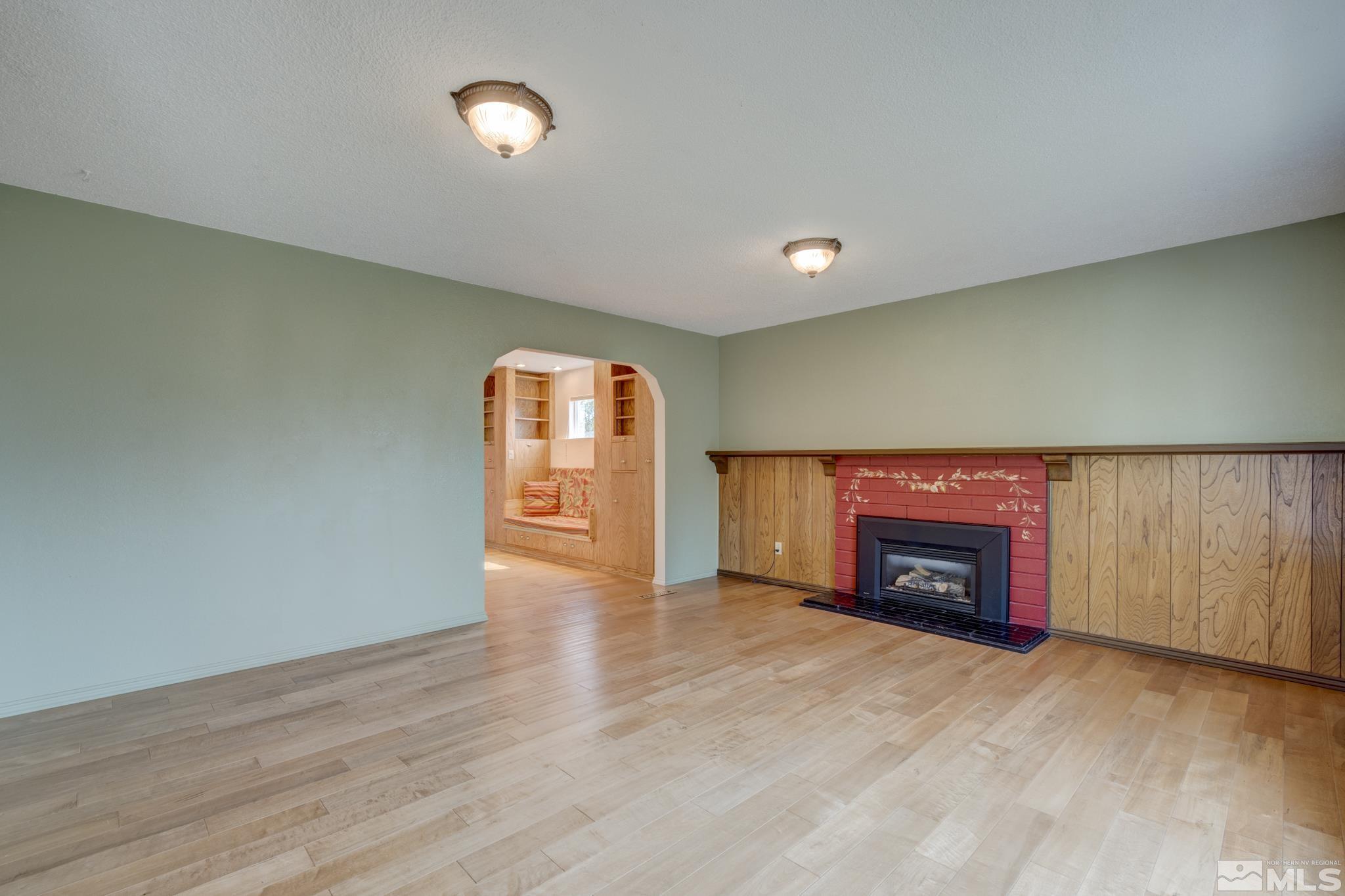 1700 O Farrell Street Reno, NV 89503 - Photo 5 of 22 an empty room with wooden floor fireplace and windows