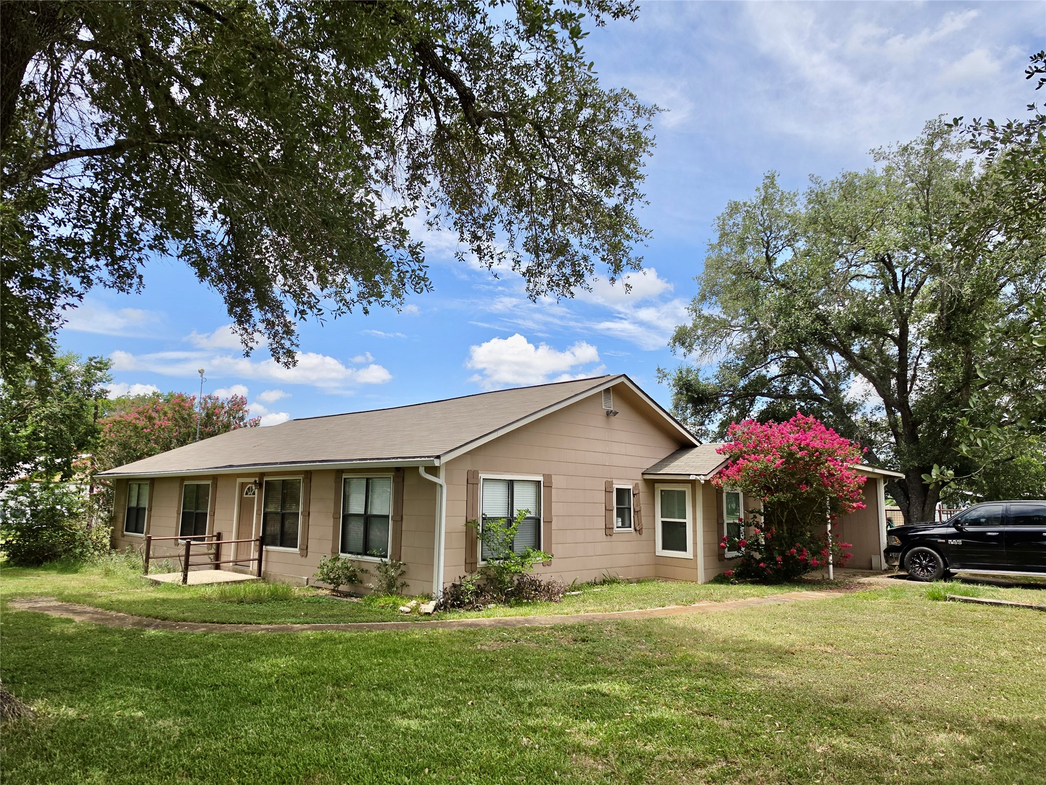 a front view of house with yard and green space