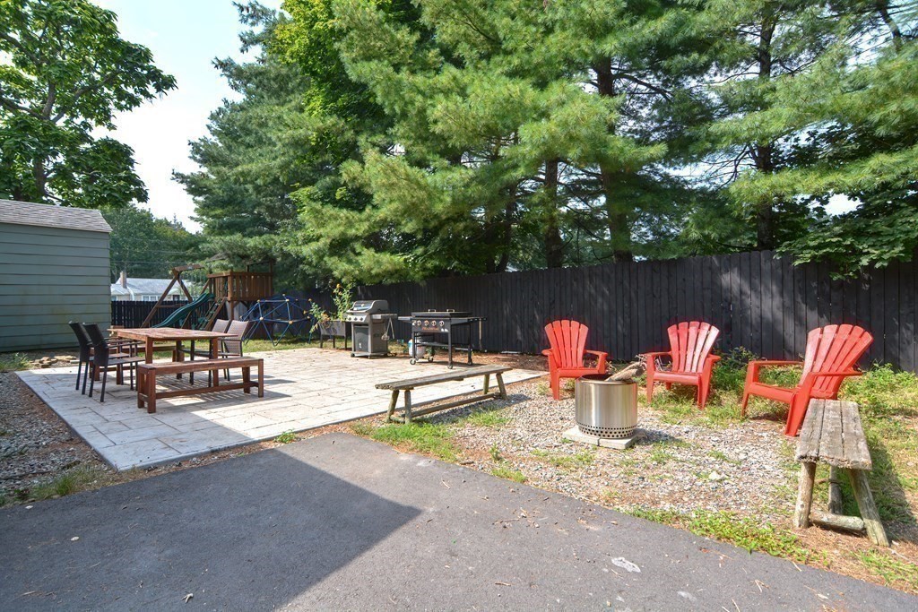 53 Frairy Street Medfield, MA 02052 - Photo 33 of 42 a view of a lake with a sitting area and a fire pit