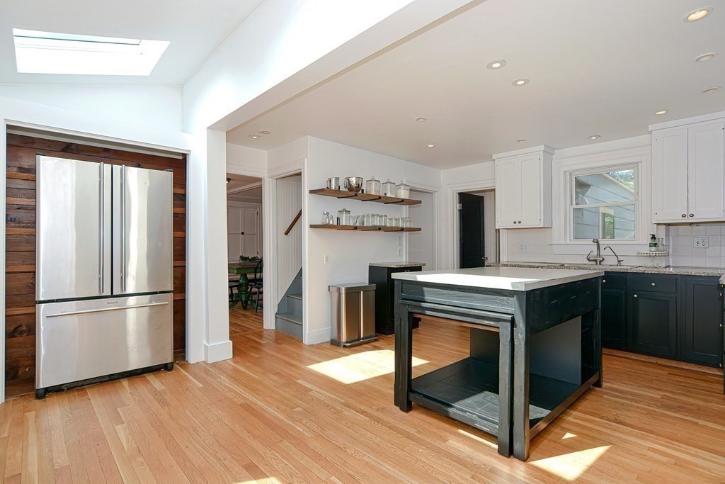 53 Frairy Street Medfield, MA 02052 - Photo 4 of 42 a kitchen with kitchen island wooden floors appliances and cabinets