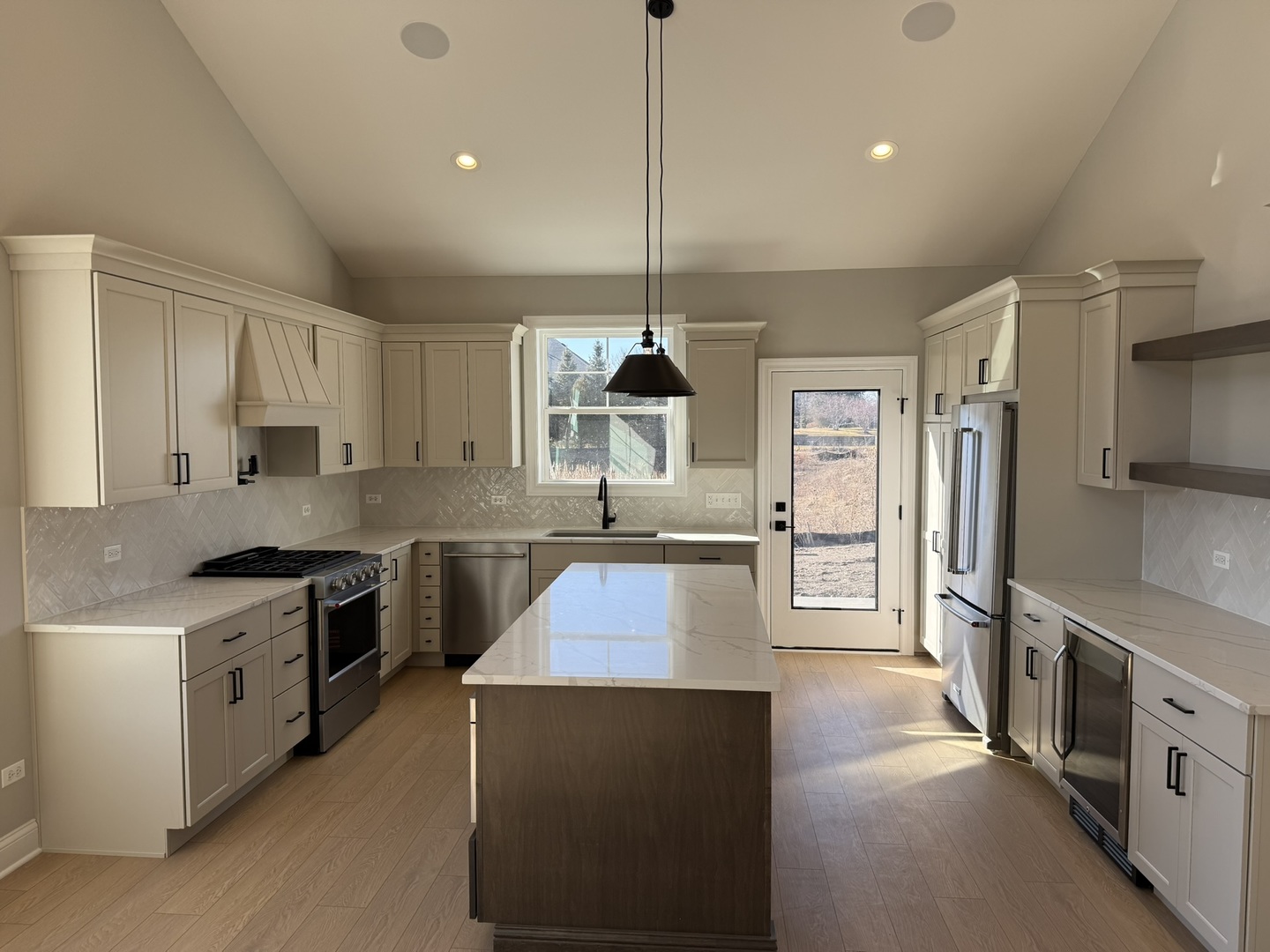 1204 Prairie Lane Lemont, IL 60439 - Photo 3 of 29 a kitchen with stainless steel appliances granite countertop a stove top oven a sink dishwasher a refrigerator and a dining table with wooden floor