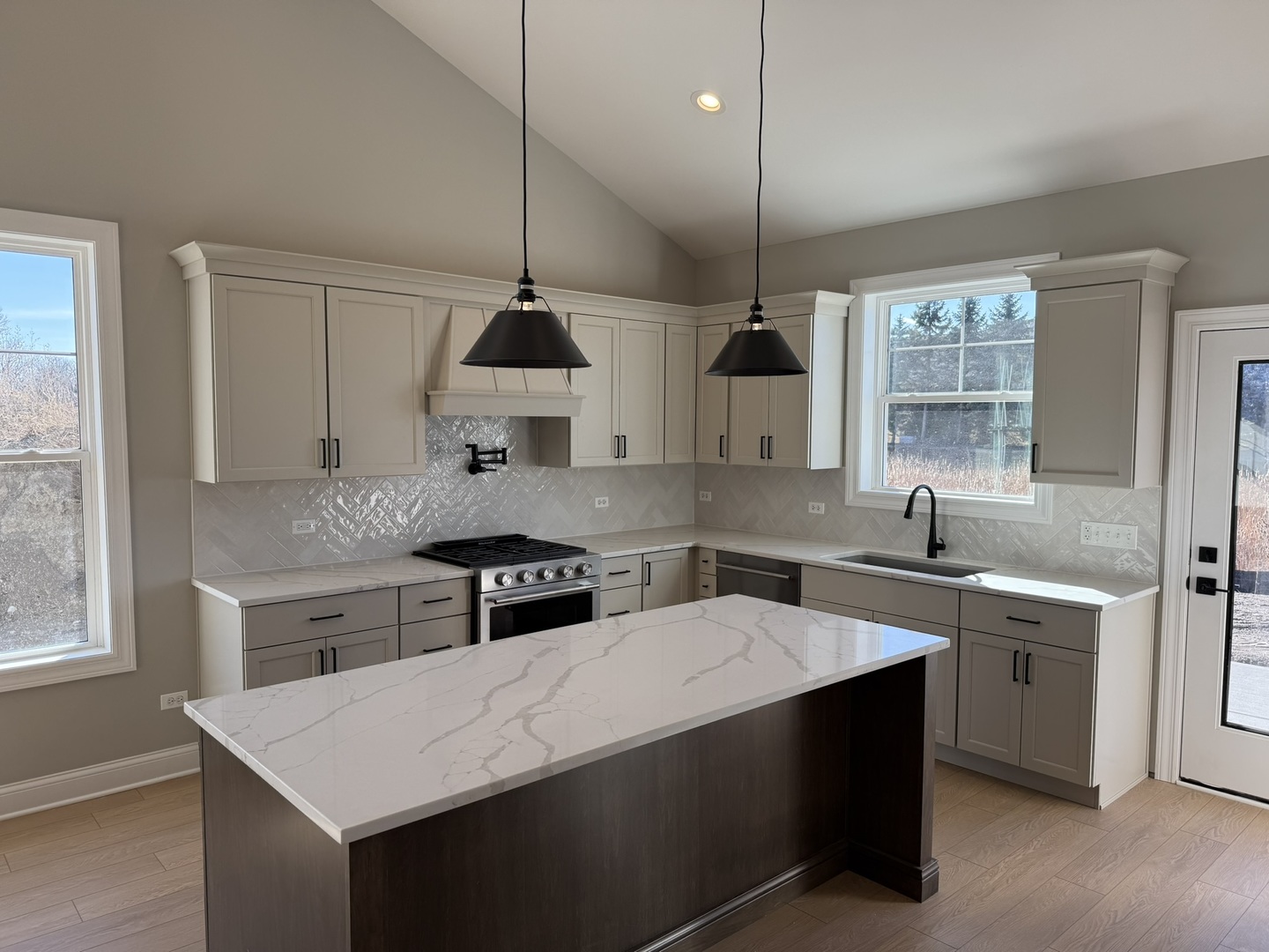 1204 Prairie Lane Lemont, IL 60439 - Photo 4 of 29 a kitchen with stainless steel appliances a sink a stove a refrigerator a center island and windows