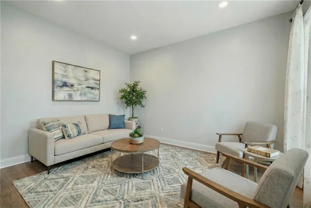 a living room with furniture and wooden floor