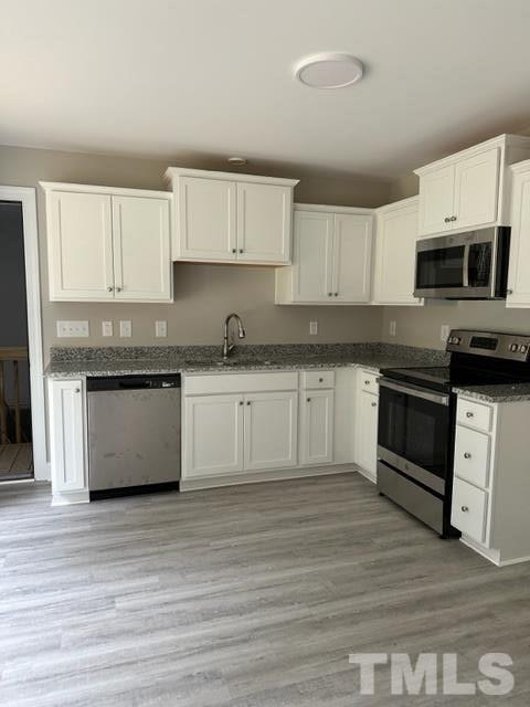 404 Pineview Road Clinton, NC 28328 - Photo 5 of 16 a kitchen with stainless steel appliances granite countertop a stove top oven a sink and white cabinets