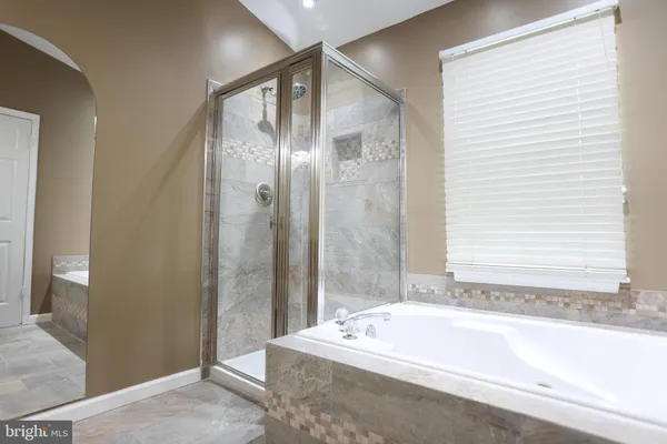 a bathroom with a tub and shower