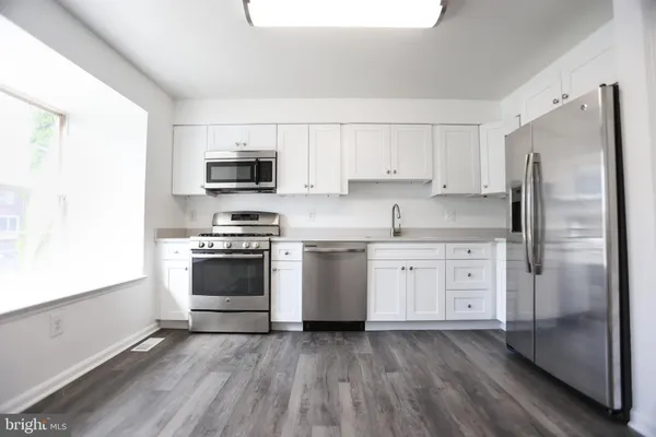 a kitchen with a refrigerator stove and microwave