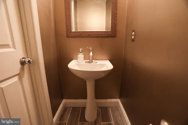 a bathroom with a sink a mirror and a shower