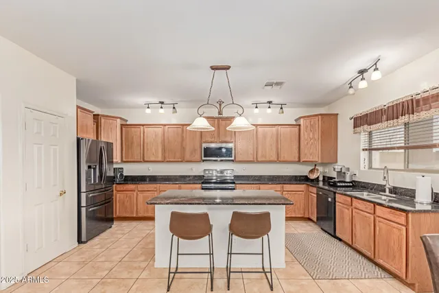 a kitchen with stainless steel appliances a sink stove and refrigerator