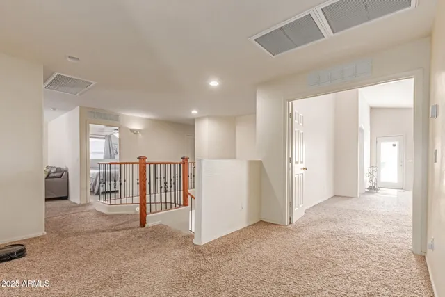 a view of a livingroom with entryway and stairs