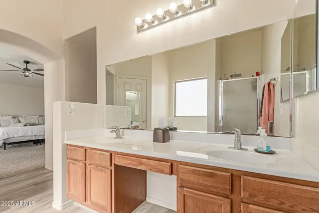 a bathroom with a double vanity sink and a mirror