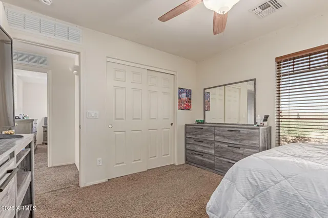 a bedroom with a bed and a dresser