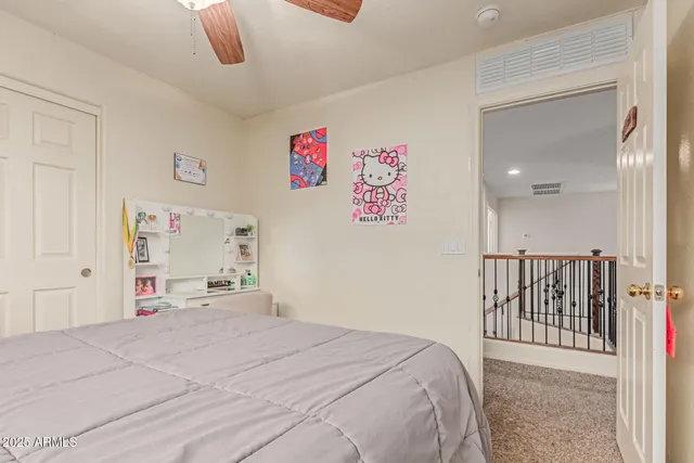 a bedroom with a bed and a large mirror