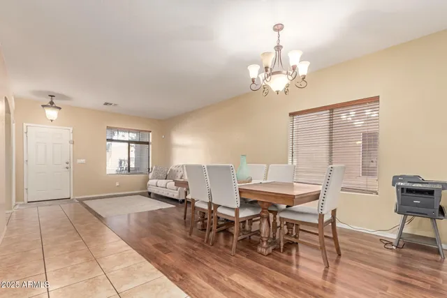 a view of a dining room with furniture wooden floor and chandelier