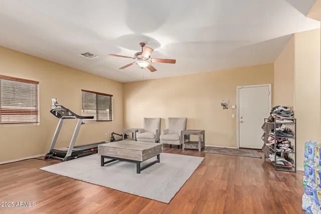 a living room with furniture and a wooden floor