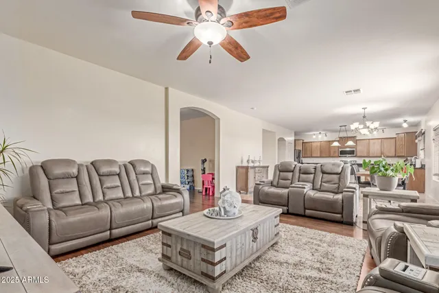 a living room with furniture and a chandelier
