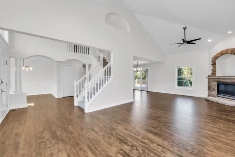 a view interior of a house with wooden floor windows and a fireplace