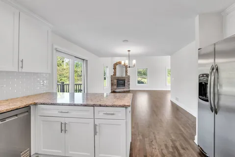 a kitchen with stainless steel appliances granite countertop a refrigerator and a sink