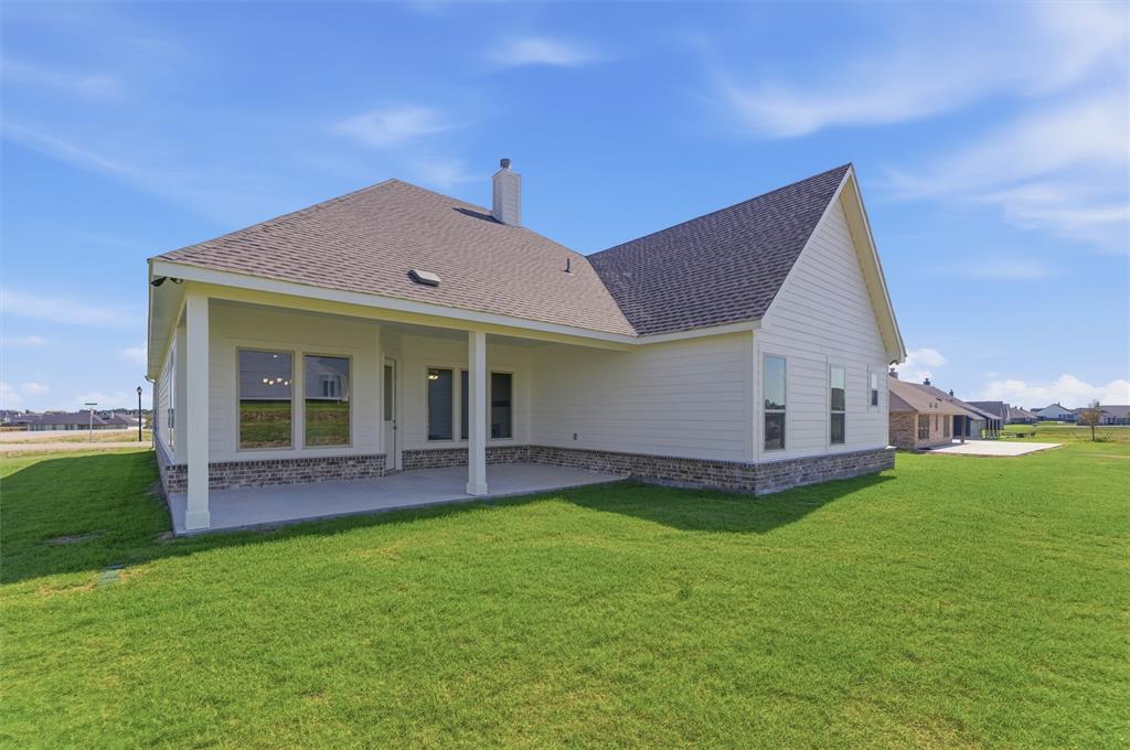 104 Snowy Owl Trail Rhome, TX 76078 - Photo 26 of 27 Expansive rear patio with covered outdoor space