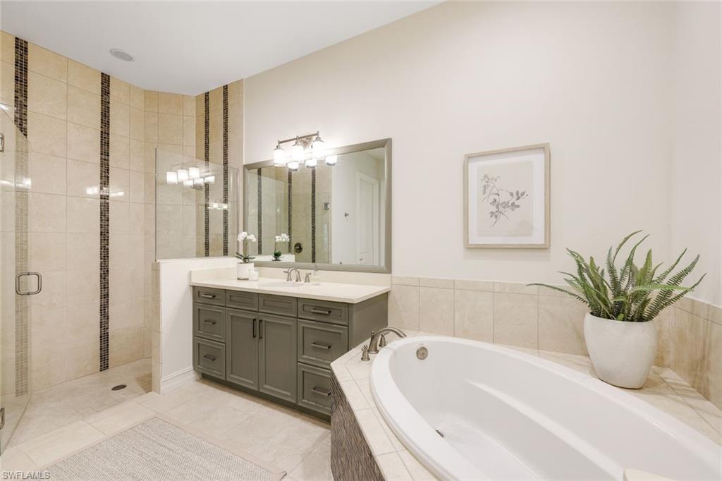 6573 Roma Way Naples, FL 34113 - Photo 21 of 49 Bathroom featuring tile patterned floors, vanity, and independent shower and bath