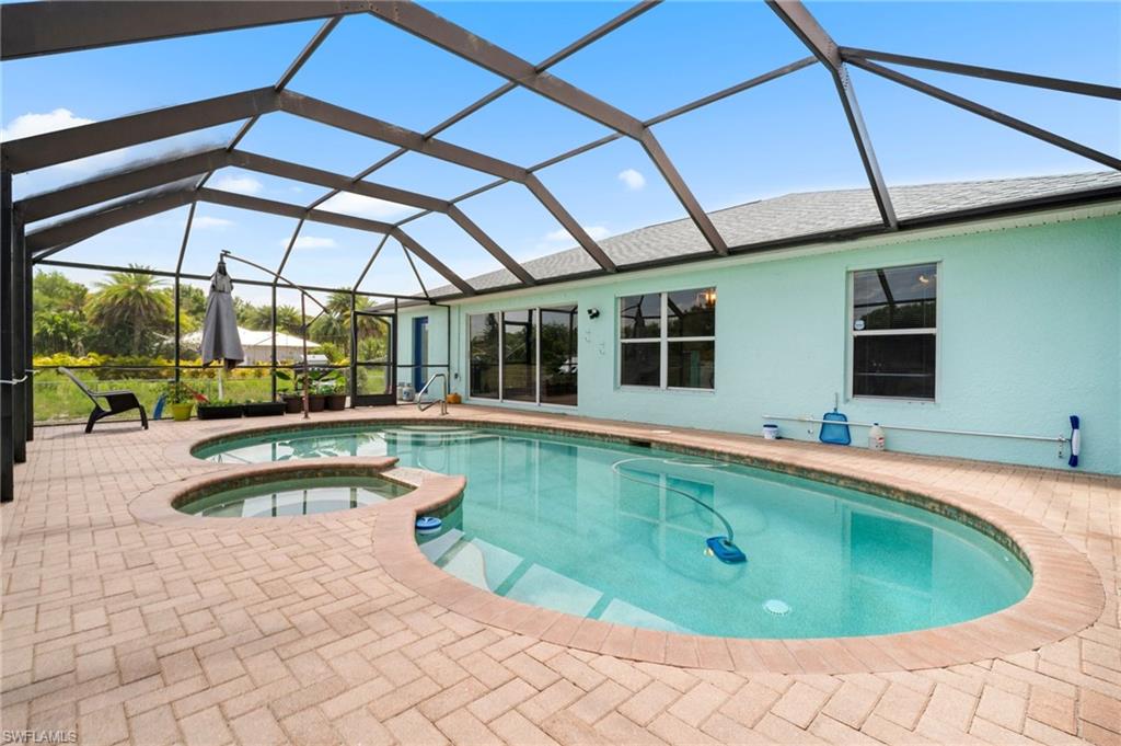 15601 Cemetery Road Fort Myers, FL 33905 - Photo 13 of 20 View of pool featuring a patio, a pool with connected hot tub, and a lanai