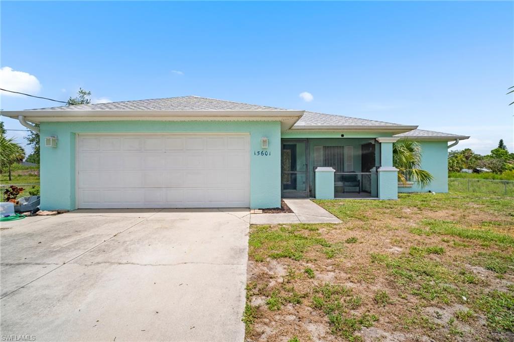 15601 Cemetery Road Fort Myers, FL 33905 - Photo 15 of 20 View of front of house with concrete driveway, stucco siding, and an attached garage