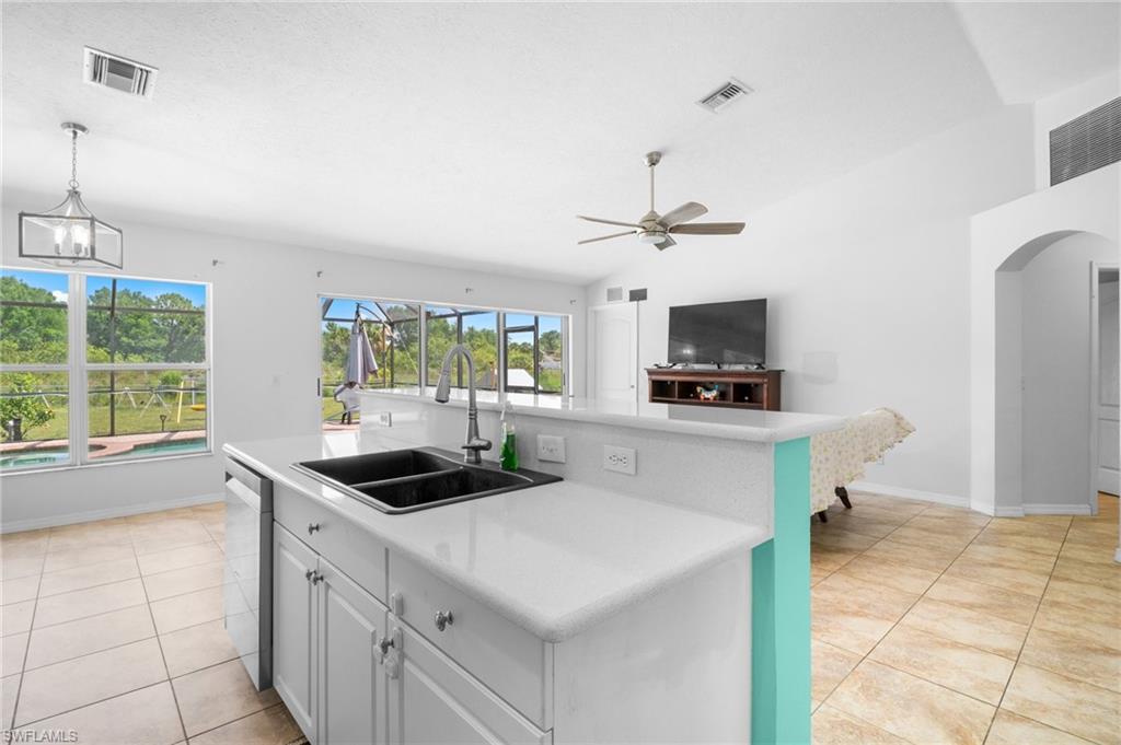 15601 Cemetery Road Fort Myers, FL 33905 - Photo 2 of 20 Kitchen with a sink, stainless steel dishwasher, light countertops, and ceiling fan