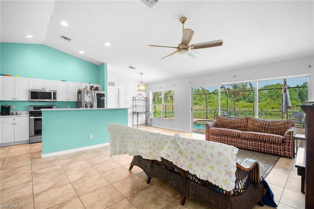 15601 Cemetery Road Fort Myers, FL 33905 - Photo 5 of 20 Living area featuring a ceiling fan, light tile patterned floors, recessed lighting, and high vaulted ceiling
