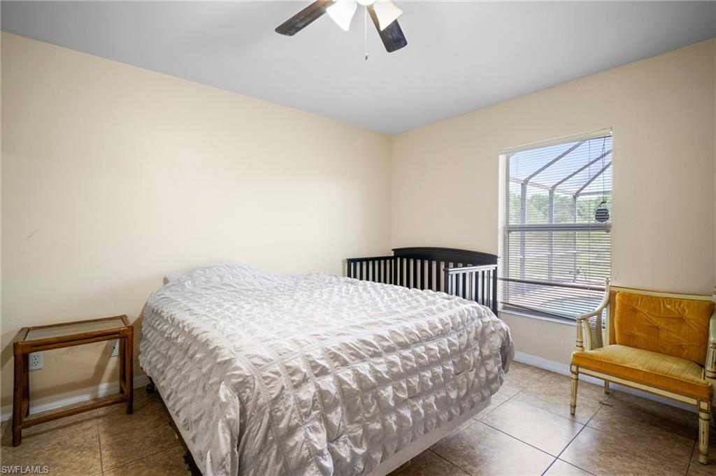 15601 Cemetery Road Fort Myers, FL 33905 - Photo 7 of 20 Bedroom featuring baseboards, tile patterned flooring, and a ceiling fan