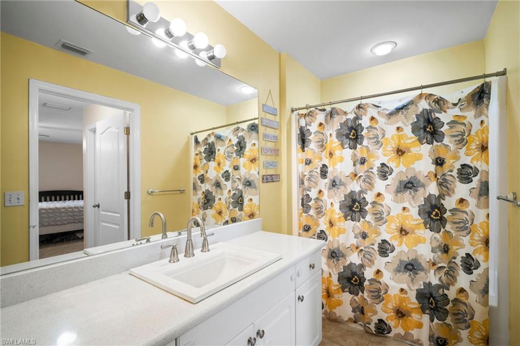 15601 Cemetery Road Fort Myers, FL 33905 - Photo 9 of 20 Bathroom with vanity, ensuite bath, tile patterned flooring, and a shower with curtain