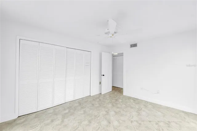 a view of an empty room with sliding glass door