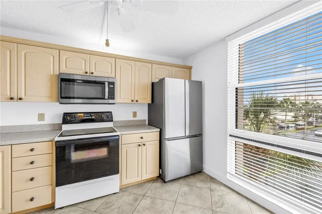 a kitchen with a sink stainless steel appliances and cabinets