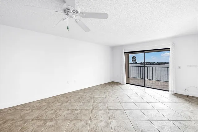 an empty room with closet and windows
