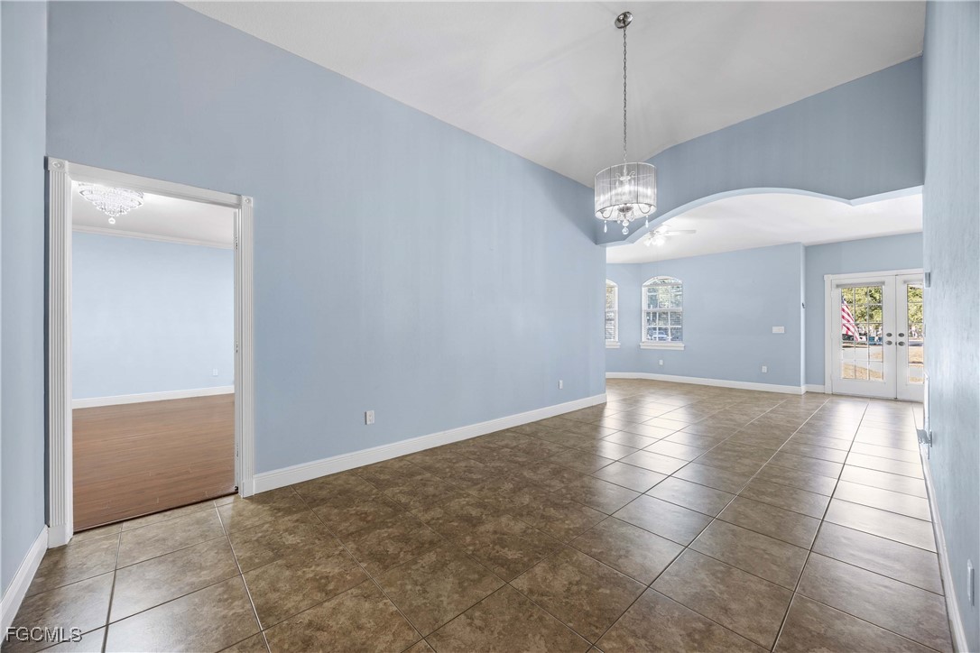 360 18th Street Northeast Naples, FL 34120 - Photo 11 of 37 a view of a room with a chandelier fan and windows