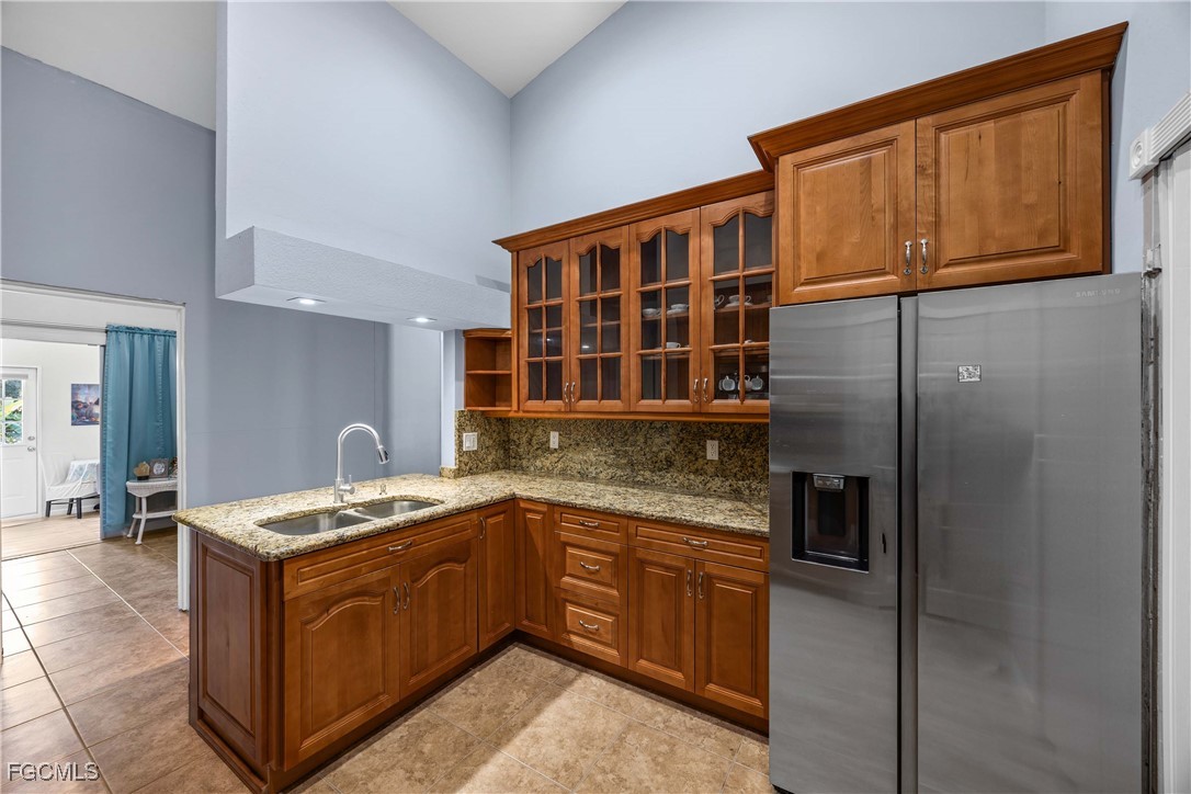 360 18th Street Northeast Naples, FL 34120 - Photo 16 of 37 a kitchen with stainless steel appliances granite countertop a sink stove and refrigerator