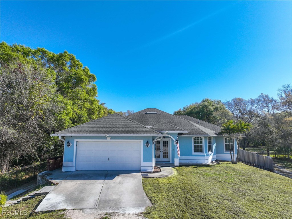 360 18th Street Northeast Naples, FL 34120 - Photo 2 of 37 front view of a house with a yard