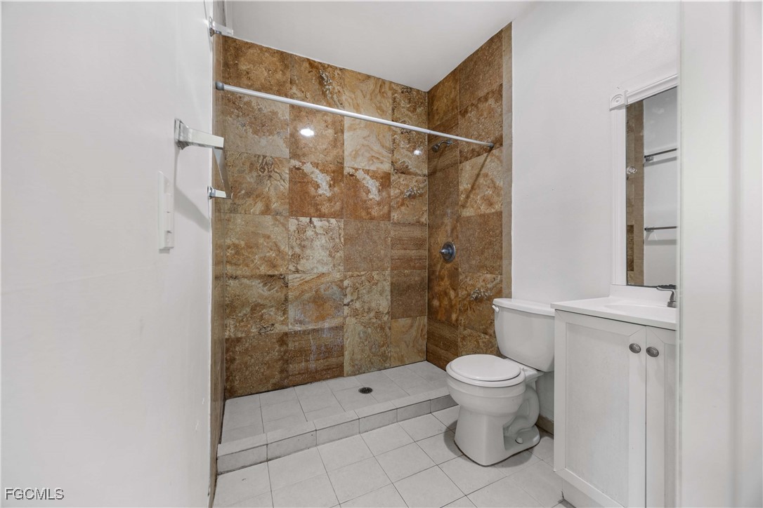 360 18th Street Northeast Naples, FL 34120 - Photo 25 of 37 a bathroom with a toilet and a shower