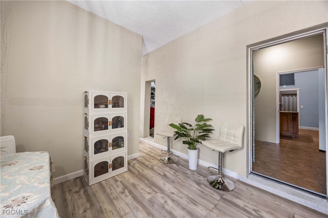 360 18th Street Northeast Naples, FL 34120 - Photo 26 of 37 a living room with furniture and a potted plant